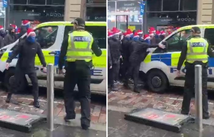 Maskierter Rangers-Fan stellt sich der Polizei, bevor er Van schlägt, während eine riesige Gruppe von Ultras in SANTA HATS zum Celtic-Spiel marschiert